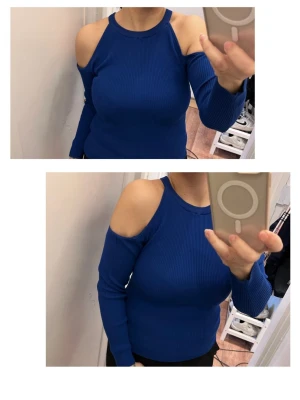 Blå ribbad offshoulder topp från H&M - Snygg blå ribbad topp från H&M med offshoulder-design och långärmade ärmar. Materialet är mjukt och stretchigt, perfekt för att skapa en cool och trendig look. Hög hals och figurnära passform som framhäver axlarna.