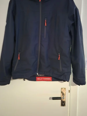 Seglar jacka - Seglarjacka från helly hansen stl M passar nog den som är 182 typ skriv ol ni vill ha bild med den på... Jackan är lite tradig på insidan och även loggan i kragen har flagnat lite