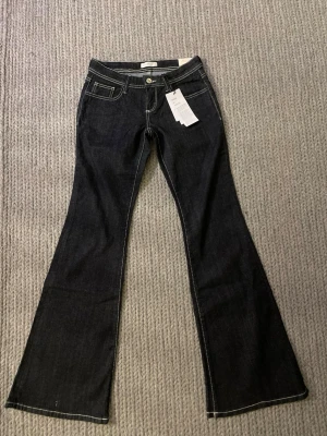 ULTRA LOW flare jeans🦋-Ny med prislapp - Mörkblå flare jeans i klassisk modell. De är helt nya och har fortfarande prislappen kvar. Väldigt enkla att matcha och passar till typ allt.🤩Anledningen till att jag säljer dessa är pga att storleken är för liten och det gick ej att returnera då jag ej hade kvittot kvar!