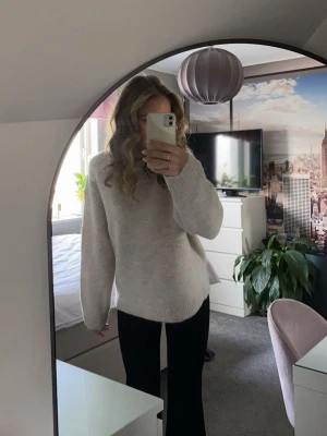 Beige stickad tröja  - Mysig beige stickad tröja från Gina Tricot med rund halsringning och avslappnad passform. Tröjan har ribbade muddar vid ärmslut och nederkant. 