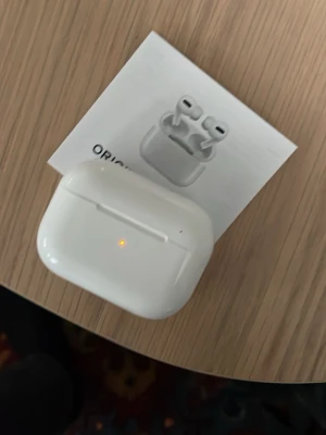 Apple - Säljer ett par vita Hörlurar som liknar AirPods Pro 2. Hörlurarna har en stilren och kompakt design med silikonproppar för extra komfort. Perfekta för musik, samtal och brusreducering. Laddningsetuiet har LED-indikator på framsidan.