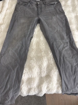 Grå raka jeans i denim - Snygga grå jeans med rak passform och klassisk femficksdesign. Jeansen har normal midja och är tillverkade i mjuk denim. Perfekta för en avslappnad och trendig look.