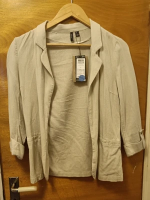 Beige kavaj/blazer från Vero Moda  - Fin blazer från Vero Moda. Strl S. Linne/viskos  Katt finns i hemmet. Rökfritt.