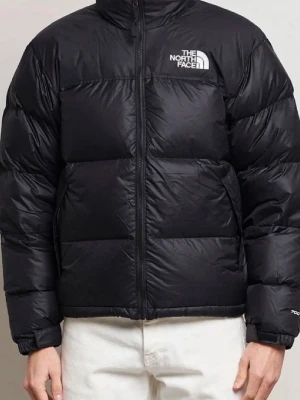  The North Face 1996 Nuptse - Säljer en svart dunjacka från The North Face med hög krage och dragkedja framtill. Jackan har en puffig design, två sidofickor med dragkedja och logga på bröstet. Perfekt för kalla vinterdagar och riktigt snygg till streetwear-stilen.