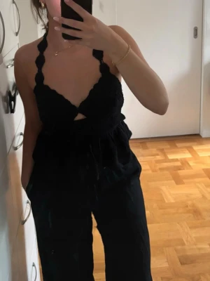Supersöt halterneck topp - Supersöt halterneck topp med virkad överdel och knyt i ryggen. Toppen har broderade blommor och utsvängd nederdel. Aldrig använd med prislappen kvar. Passar även för en xs beroende på önskad passform. 