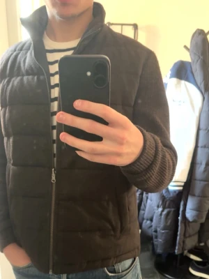 Mörkbrun  cardiganjacka - Snygg mörkbrun cardiganjacka med quiltade partier och stickade ärmar. Jackan har hög krage, dragkedja framtill och ribbade muddar. Märke med logotyp på ärmen. Perfekt för lager-på-lager och chill stil. PRIS KAN DISKUTERAS👇👇