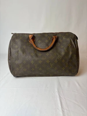 LV Speedy väska - Säljer denna LV speedy monogram väska! Detta är en av LVs mest ikoniska väskor! Den är i okej skick kolla bilder! Dragkedjan fungerar! Väskan är vintage och 100% äkta