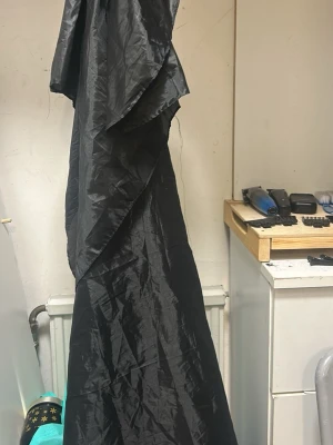 Barberarset med klippkappa och maskiner - Säljer ett komplett barberarset med svart klippkappa i syntetmaterial, tre olika hårtrimmers (varav en i guld och svart, en i svart och en i metall med mönster), borstar och halsremsa. Perfekt för dig som vill fixa frisyren hemma eller starta eget.