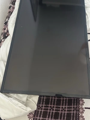 Svart platt tv - En svart platt tv med bred ram och blank yta. Skärmen har en rektangulär form och passar perfekt till dator eller som extra skärm till gaming eller film. Tecken på användning. Sladd och andra fenomen ingår ej. Upphämtning i Landskrona!