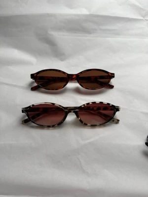 Solglasögon 2 st - Helt nya och oanvända. Båda medföljer