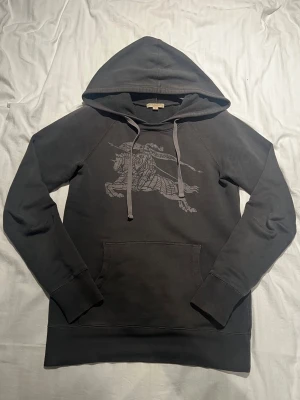 Burberry hoodie - En väldigt fin sweatshirt/hoodie hybrid ifrån lyxmärket burrberry, den har inga defekter från vad jag kan se och är i storlek S. Använd endast ett fåtal gånger och är i väldigt fint skick. Nypriset på dessa hoodies ligger mellan 4 500 och 6 000 kronor så mitt pris är billigt jämfört med nytt. Det är bara att skriva om du skulle vara i behov av fler bilder! Priset är inte hugget i sten så det kan sänkas vid snabb affär! 