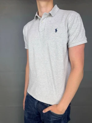 Ralph Lauren Piké - Ralph Lauren piké Märke: Polo Ralph Lauren Storlek: L Passform: Custom Slimfit Färg: Grå Skick: Mycket bra Beskrivning: utan defekter Modellen på bilden: 183 cm / 75 kg