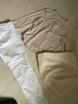 Beige långärmad topp i bomull - Snygg beige långärmad topp med rund halsringning. Tillverkad i mjuk bomull, perfekt för en avslappnad och stilren look. Passar bra till både jeans och kjol.  Vita nya Stretchjeabs från HM storlek 34 och kjol i 100% lana vergine     Allt för 99:-