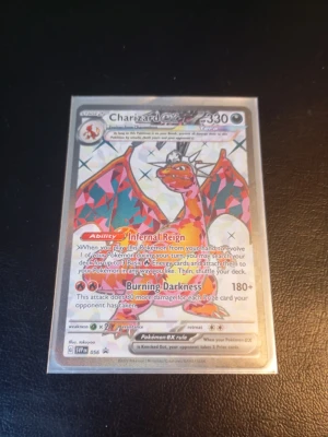Charizard ex Pokémonkort - Säljer ett Charizard ex  Pokémonkort med holografisk effekt. Kortet har färgstark design med röd, orange och svart Charizard och detaljer i silver. Kortet är från Scarlet & Violet-serien och har 330 HP. Perfekt för samlare eller Pokémonfans. Skrapig yta. Fraktas i plastfodral.