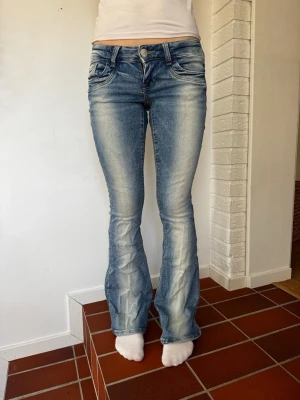 Blå bootcut jeans ”kvarg” - Snygga blå bootcut jeans med ljus tvätt ”kvarg jeans” . Jeansen har klassiska fem fickor, låg midja och utsvängda ben. Från Gina 14+ storlek S. Perfekta för en avslappnad och trendig look. Skriv ifall frågor