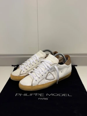 Phillippe Model Sneakers - Phillipe Model Sneakers i storlek 41. Skick 7.5/10, en liten skada på ena skon och lite tecken på användning. Pris 599. Fraktar samma dag 