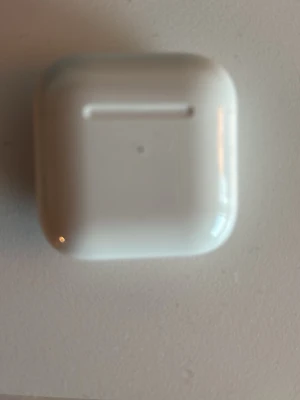 Apple AirPods med laddningsetui - Säljer ett par vita Apple AirPods med tillhörande laddningsetui. Trådlösa hörlurar i stilren och kompakt design, perfekt för musik, samtal och poddar. Etuiet är i blankt plastmaterial och hörlurarna har den klassiska Apple-looken. Helt oanvända!