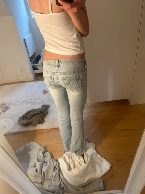 Ljusblå True Religion jeans bootcut - Säljer ett par ljusblå jeans från True Religion low waist bootcut dem är använda få gånger och är precis som ny. Köpt för 1200kr 