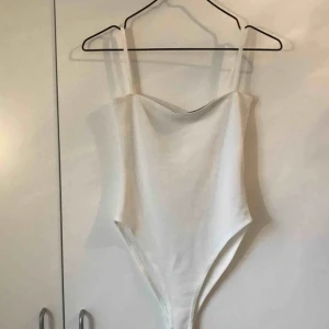  - En jättefin vit body, passar superbra till highwaisted shorts eller kjol!
