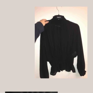  - En genomskinlig fest tröja/blus, med en krage och volanger, storlek Xs  Om det ska skickas, frakt tillkommer 59kr totalt för tröjan då.