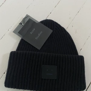 Acne mössa - Säljer min svarta acne mössa som jag köpte förra vintern så den är knappt använd. Den är i fint skick och prislapp medföljer.