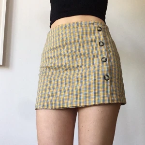 Kjol från Pull & Bear - Höstig kjol med knappar på sidan (stängs dock med osynlig dragkedja i midjan) Strl M men liten i storleken! Köparen betalar frakt!