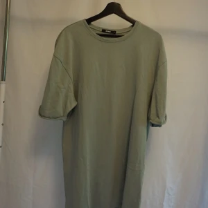 Tshirt klänning - Tshirt klänning från gina i mintgrön färg. Strl xs men passar s-m beroende på hur man vill att den ska sitta. 