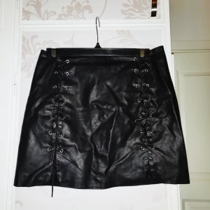Faux leather kjol från Forever 21 - En av mina favoritkjolar från Forever 21 i faux läder med hög snörning man kan spänna åt på båda sidorna samt dragkedja där bak! Säljer då den är i L och inte passar mig men bild 2 ger en uppfattning av kjolen, den är i väldigt bra skick🥰 44kr frakt med PostNord!