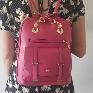 Hot pink väska - Väska i riktigt 'hot pink' veganskt läder. Är allmänt mycket utöver det vanliga. några få små-skador (se bild 3) varav de flesta sitter som tur är på baksidan, verkligen inget störande, i övrigt som ny. Säljer för 150kr exkl frakt (63kr) 