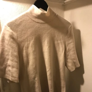 - Wool blend High neck sweater från COS. Off white. Strl M