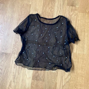 NY Söt topp i mesh med pärlor i storlek S - En söt svart meshtopp med fastsydda pärlor. Passar perfekt till fest. Aldrig använd, i nyskick. Storlek S men kan även passa M.