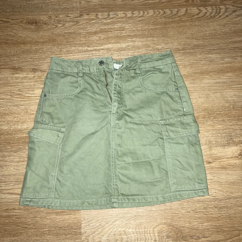 Grön jeans kjol med fickor på sidorna. Har använts enstaka gånger och har en lite lösare passform.. Kjolar.