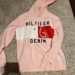 Hoodie rosa - Säljer denna rosa hilfiger hoodie, den skönaste hoodien jag testat men tyvärr inte i min stil. Använda Max 3 gånger. Nypris ca 600kr säljer för 100. Kan mötas i täby annars frakt 60kr🤍