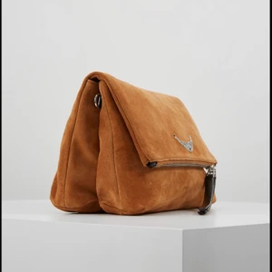 Zadig Väska - Super snygg och unik modell av en Zadig väska. Tyvärr är den rätt sliten och pga detta det låga priset!  Ni får skiva till mig privat om ni vill ha mer och tydligare bilder:) Det ingår även två väskband i köpet (se nedan andra bilden)  Jag köpte väskan för 3500kr på en Zadig butik.  Frakten står köparen för själv:)