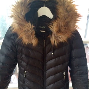  - Hollies dunjacka 
Modell: Aspen 
Färg: svart 
"Feakfur" 