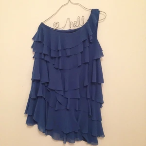  - Kornblå underbar klänning med volanger i olika nivåer. Sommarens måste! 