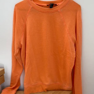 Orange sweatshirt från Forever 21 - Skön orange tröja från Forever 21 i strl S. Ganska tunn i materialet. Är liiiite mer åt det ljusa hållet i färgen som på bild 3. Använd ett par gånger men i fint skick! Kan mötas upp i Malmö annars kostar frakten 55 kr.