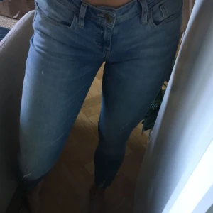  - Sturörsjeans med små slitningar nertill och vid knät