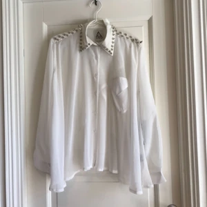  - Transparent skjorta med nitar och öppen rygg från Unif. Aldrig använd med etikett kvar.