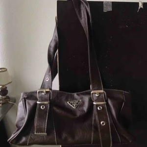  - Gulligaste axelväskan! Prada, köpt på Humana. Har två fack inuti varav ett har ett extra innerfack. Rymlig och användbar. Superbra skick! Säljer för att jag inte är så hype på märkesväskor. Köpare står för frakt. Skriv för fler bilder ❤️