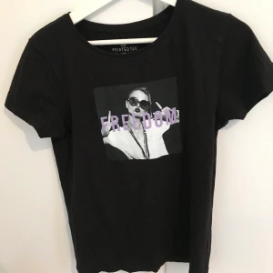 Svart t-shirt med tryck. - En jättefin svart t-shirt med ett tryck ”freedom” och en bild. Väldigt fint skick. Köpt på Primark. I storlek XS. Frakt tillkommer som köparen står för. Priset går att diskutera. Vid frågor så är det bara att höra av sig.
