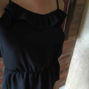  - En fin svart topp med volang 