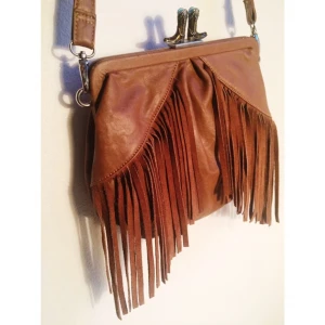  - Axelbandsväska med fransar. Innefack med dragkedja.
