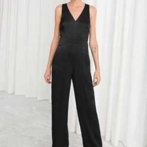  - Svart silkig jumpsuit från & other stories. Använd två ggr. Gått lite trådar på knapparna, som var så när jag fick den från onlinebeställning. Knappt längst sidan och dragkedja i nacken. Strl S