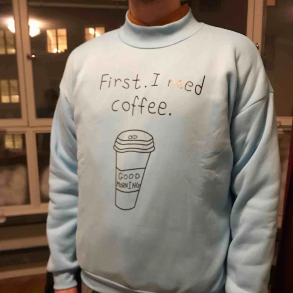 A Christmas gift that was one size too big. Sky blue sweater with tagline “coffee first”, new, never worn. Tröjor & Koftor.