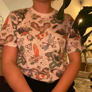 Harry Potter  - Vit t-shirt med supercoolt Harry potter-tryck. Det är ugglor, döskallar, flygande nycklar och mycket mer på den och är den perfekta tröjan för ett Harry Potter fan eller bara en cool tröja 