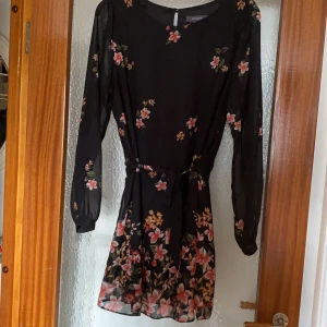 Blommig klänning strl. 46 - Svart blommig klänning i strl. 46. Pris exkl. frakt, köparen står för frakten. 