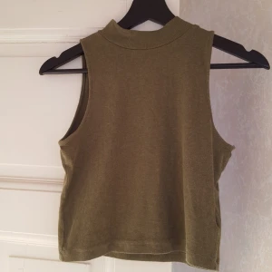  - kort olivgrön tröja med hög hals, jättefin på. passar s och m och l kanske då den är väldigt strechig i tyget. frakt tillkommer