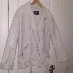  - Vinterjacka i biker modell. Vit/grå/beige i färgen. Mocka imitation. Använd 1 gång