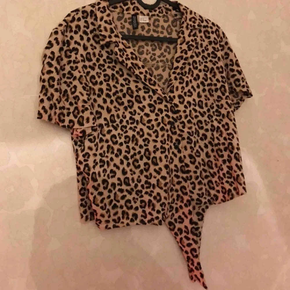 Säljer min snygga leopardmönstrade tröja ifrån H&M i storlek 38. Sluts med knappar och man kan knyta i änden utav tröjan. Använd 1 gång . T-shirts.